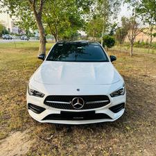 Mercedes-Benz CLA 200 sport back coupe sedan , ultimate AMG sport package 
1.6 cc twin turbocharged with 10 speed triptonic transmission.
Model 2021 registered Punjab 2022
Shahnawaz Pakistan import 
Mileage 18500 km
First owner vehicle 
Diamond white metallic colour with black two tone Dezine line AMG interior.
Bumper to bumper original condition & spotless.
Top of the line specs & customised options.
Glass panoramic electric sunroof 
Two tone leather AMG bucket seats
Multi power & 11 zone adjustment seat 
Heated & ventilated seats
8 zone climate control air conditioning 
Full dashboard single line  led cluster display.
64 colours ambient interior lighting 
Burdmaster pro premium surround sound system 
Multi 360 degree cameras 
Auto pilot 
Apple CarPlay & android apps
Electric multi zone massager seats 
Perfume air package 
Adapted Radar 
Adapted cruise control 
Line assisted & blind spot monitor 
Privacy glasses package 
All zone parktronic sensors access 
AMG suspension & break
Full AMG body kit
19” AMG alloy wheels 
Duel AMG mufflers
Further information please call & visit at Victory Cars Lahore.