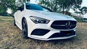 Mercedes-Benz CLA 200 sport back coupe sedan , ultimate AMG sport package 
1.6 cc twin turbocharged with 10 speed triptonic transmission.
Model 2021 registered Punjab 2022
Shahnawaz Pakistan import 
Mileage 18500 km
First owner vehicle 
Diamond white metallic colour with black two tone Dezine line AMG interior.
Bumper to bumper original condition & spotless.
Top of the line specs & customised options.
Glass panoramic electric sunroof 
Two tone leather AMG bucket seats
Multi power & 11 zone adjustment seat 
Heated & ventilated seats
8 zone climate control air conditioning 
Full dashboard single line  led cluster display.
64 colours ambient interior lighting 
Burdmaster pro premium surround sound system 
Multi 360 degree cameras 
Auto pilot 
Apple CarPlay & android apps
Electric multi zone massager seats 
Perfume air package 
Adapted Radar 
Adapted cruise control 
Line assisted & blind spot monitor 
Privacy glasses package 
All zone parktronic sensors access 
AMG suspension & break
Full AMG body kit
19” AMG alloy wheels 
Duel AMG mufflers
Further information please call & visit at Victory Cars Lahore.