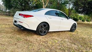 Mercedes-Benz CLA 200 sport back coupe sedan , ultimate AMG sport package 
1.6 cc twin turbocharged with 10 speed triptonic transmission.
Model 2021 registered Punjab 2022
Shahnawaz Pakistan import 
Mileage 18500 km
First owner vehicle 
Diamond white metallic colour with black two tone Dezine line AMG interior.
Bumper to bumper original condition & spotless.
Top of the line specs & customised options.
Glass panoramic electric sunroof 
Two tone leather AMG bucket seats
Multi power & 11 zone adjustment seat 
Heated & ventilated seats
8 zone climate control air conditioning 
Full dashboard single line  led cluster display.
64 colours ambient interior lighting 
Burdmaster pro premium surround sound system 
Multi 360 degree cameras 
Auto pilot 
Apple CarPlay & android apps
Electric multi zone massager seats 
Perfume air package 
Adapted Radar 
Adapted cruise control 
Line assisted & blind spot monitor 
Privacy glasses package 
All zone parktronic sensors access 
AMG suspension & break
Full AMG body kit
19” AMG alloy wheels 
Duel AMG mufflers
Further information please call & visit at Victory Cars Lahore.