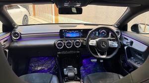 Mercedes-Benz CLA200  AMG -S ( twin turbocharged ) night black package 
Model 2021 registered 2022 in Islamabad 
Shahnawaz import.
Pearl black metallic with twin shadesd Dezine line AMG leather interior 
Mileage 24000 km
Bumper to Bumper original & spotless condition 
Top of line customised specs. 
Memory package, 14 electric power seats ejectment , heated & ventilated seats 
AMG spot bucket seat 
Multi zone climate control air conditioning 
Burmaster pro. surround sound entertainment system 
Panoramic electric sunroof 
Head up display 
Multi massager seats package 
Telescopic electric steering wheel 
Paddle shifter 
Adapted cruise controls 
Radar & adapted line accessed 
360 degrees cameras 
Multi zone auto parktronic package 
64 colours ambient lights interior 
Perfume package 
Multi driving modes eco, individual, sport, sport + & comfort.
Privacy glass package 
AMG sport suspension 
Wireless charger 
Wireless Apply CarPlay & android apps 
AMG muffler with change sound 
19 “ AMG sport alloy wheels 
Full AMG body kitted 
GT line front grill
Flat screen o led smart cluster 
Adapted led laser headlights 
Further information please call & visit at Victory Cars jail road Lahore.