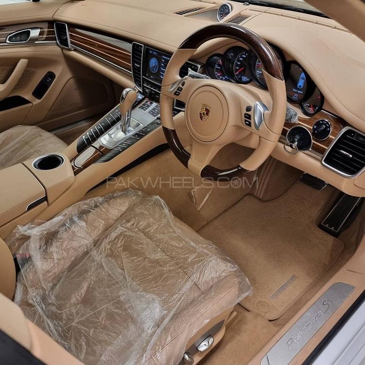 Porsche Panamera S Hybrid
3000cc V6 Engine
Model 2013
Registered 2013
16000 Km
White
Luxor Beige Interior
Yachting Mahogany Interior Package
Yachting Mahogany Heated Multifunction Stearing Wheel
Sport Chrono Package
Soft Closing Doors
Porsche Crest Embossed on Headrest
Sunroof
BOSE Sound System
Rear Automatic Blinds
Height Control
Adjustable Suspension
Single Owner
Spare Key


Location: 

Prime Motors
Allama Iqbal Road, 
Block 2, P..E.C.H.S,
Karachi
